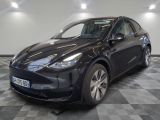 the tesla e - pace is parked on a checkered floor in a showroom
