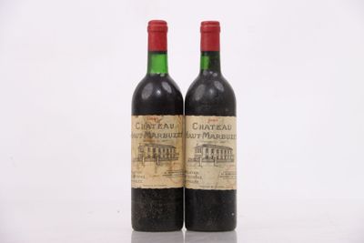 two bottles of wine sitting on top of a table next to each other