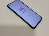 a close up of a phone on a table with a logo on the screen