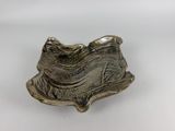 an image of a silver plate on a white surface