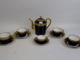 five cups and a teapot on the table