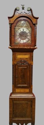 a wooden grandfather clock that is on display on the floor