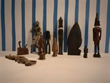 many wooden figurines displayed on a white table