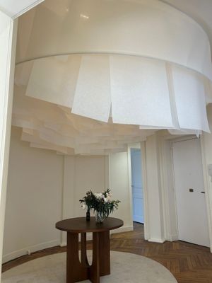 a table with a vase of flowers on it in the middle of a room