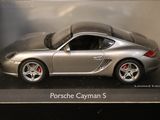 a silver toy car in a display case on a table