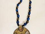 a close up of a necklace on a white surface