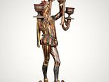 a statue of a man holding a bowl and a candle
