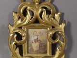 a gold frame with a picture of a woman on it