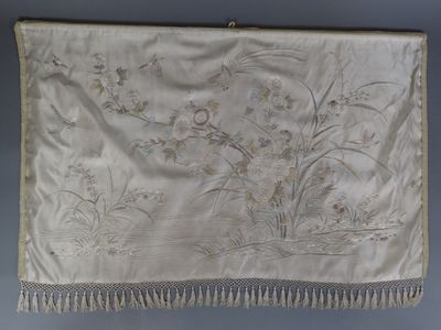 an antique silk embroidered wall hanging with flowers and birds on it