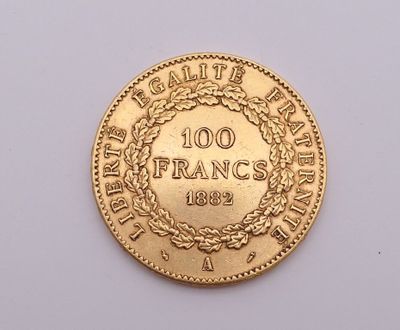 a close up of a gold coin on a white surface