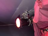 a woman that is standing in front of a stage light