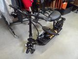 a scooter that is sitting on the floor next to a rack of clothes