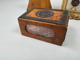 a small wooden box sitting on a table next to a picture frame