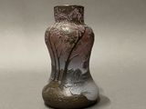 a vase that has a picture of a tree on it