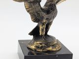 an image of a statue of an eagle on a marble base