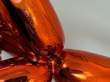 an orange balloon shaped like a dog with a nose