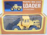 a yellow toy truck with a crane in the box