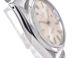 a silver watch with a pink dial on it