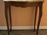 a small table with a mirror on top of it