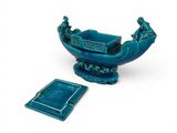 blue ceramic bowl with a book and coaster on a white background