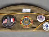 an image of a hat with badges on it sitting on a table
