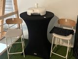 a black table with two chairs next to a ladder