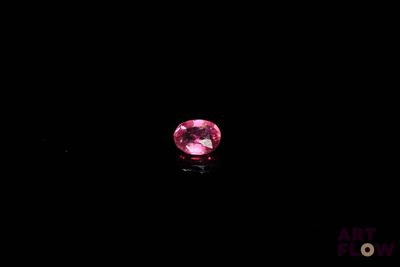a pink diamond on a black background