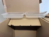 two plastic containers sitting in a cardboard box