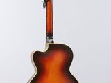 a close up of a guitar on a stand against a white background