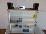 a white cabinet with a cd player on top of it