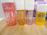 bottles of sun lotion sitting on a table next to a bottle of lotion