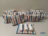 several bags of toiletries are lined up on a table