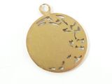 a close up of a gold plated pendant with a bird on it