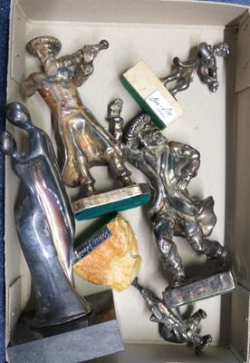 a box with silver figurines in it on a blue surface