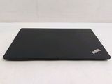 a black laptop sitting on a table with a white background