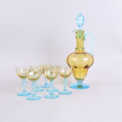 a lot of wine glasses and a decanter on the table