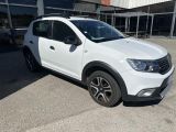 the white dacia is parked in front of a building