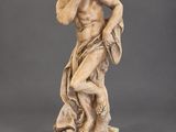 an image of a statue of a man holding a dog