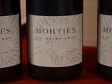 three bottles of wine sitting on a table