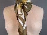 brown and white striped scarf on a mannequin neck