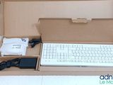 a box with a keyboard, mouse, and charger in it