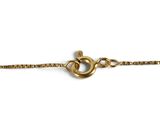 a close up of a gold chain on a white background