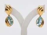 a pair of blue topaze and gold earrings