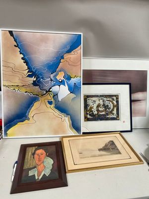 a desk with a lot of art and pictures on it