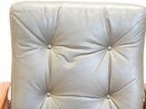 grey leather chair with wooden arms and back rest