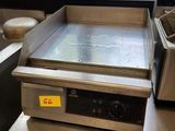 an image of a counter top with a fryer and a pan on it