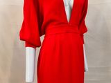 red dress on mannequin display with white mannequin in background