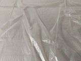 a plastic sheet covering a bed with a wooden frame