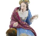 a figurine of a man sitting on a rock