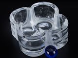 a glass ashtray with a blue glass ball in it